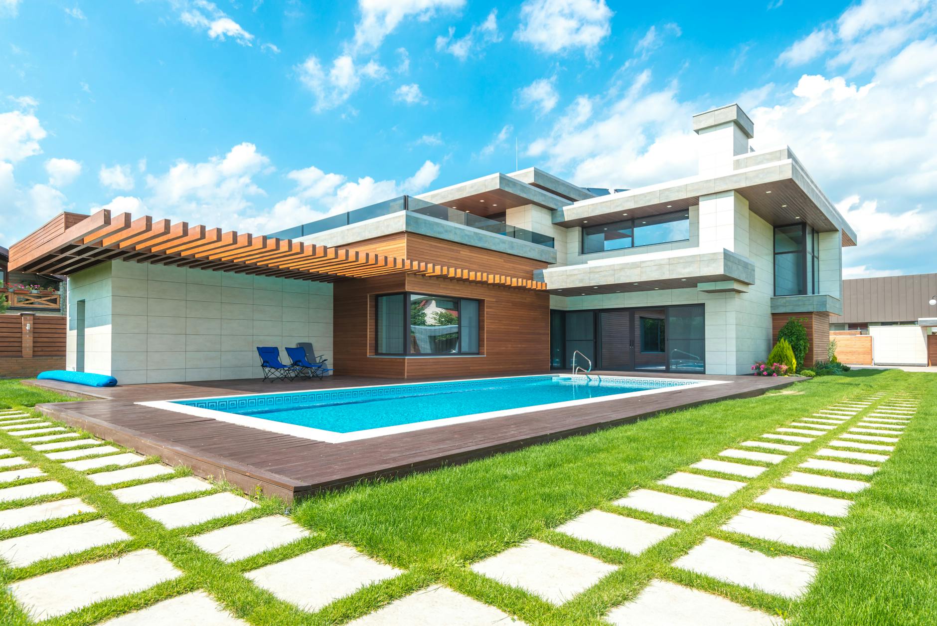 Modern Adelaide backyard concrete pool with frameless glass fencing and outdoor entertaining area at golden hour